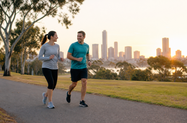 Two beginner runners moving at a conversational pace in an Australian park